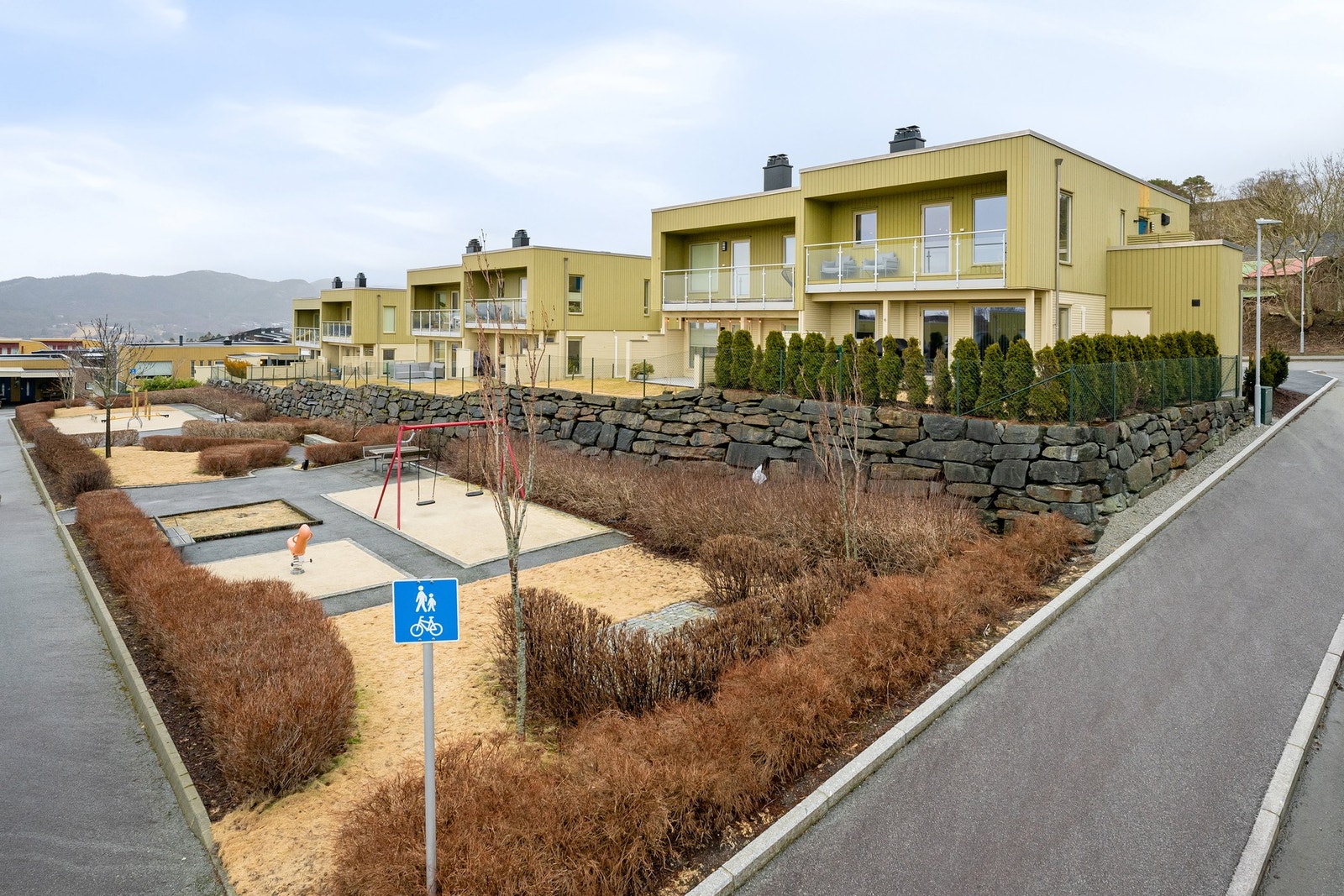 I nærområdet finner man flere velstelte fellesområder med lekeplasser og hyggelige sitteplasser Galleribilde