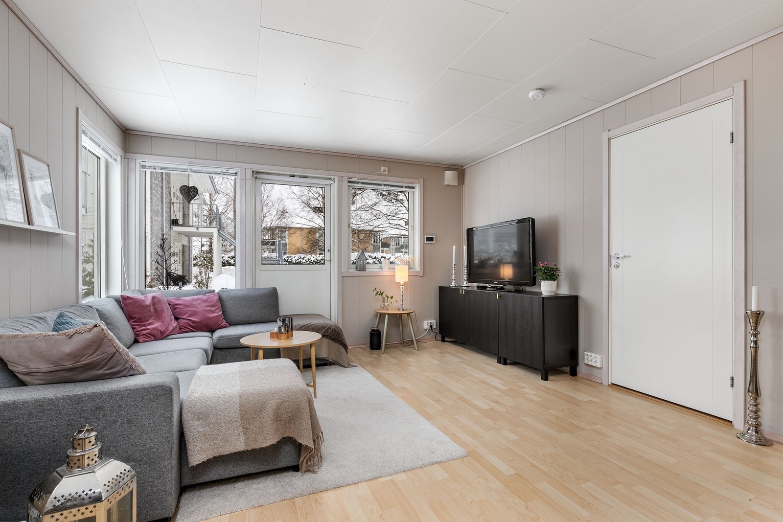 Lys og trivelig stue med store vinduer som sørger for fint med lysinnslipp i boligen Galleribilde