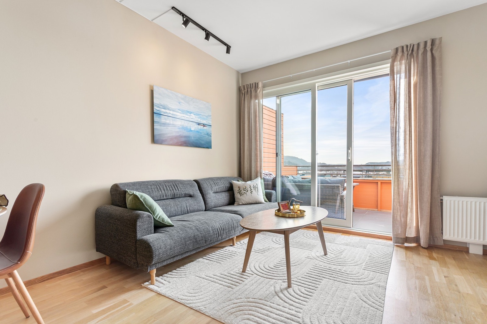 Store vinduer og god takhøyde gir stuen en lun og luftig atmosfære. Galleribilde