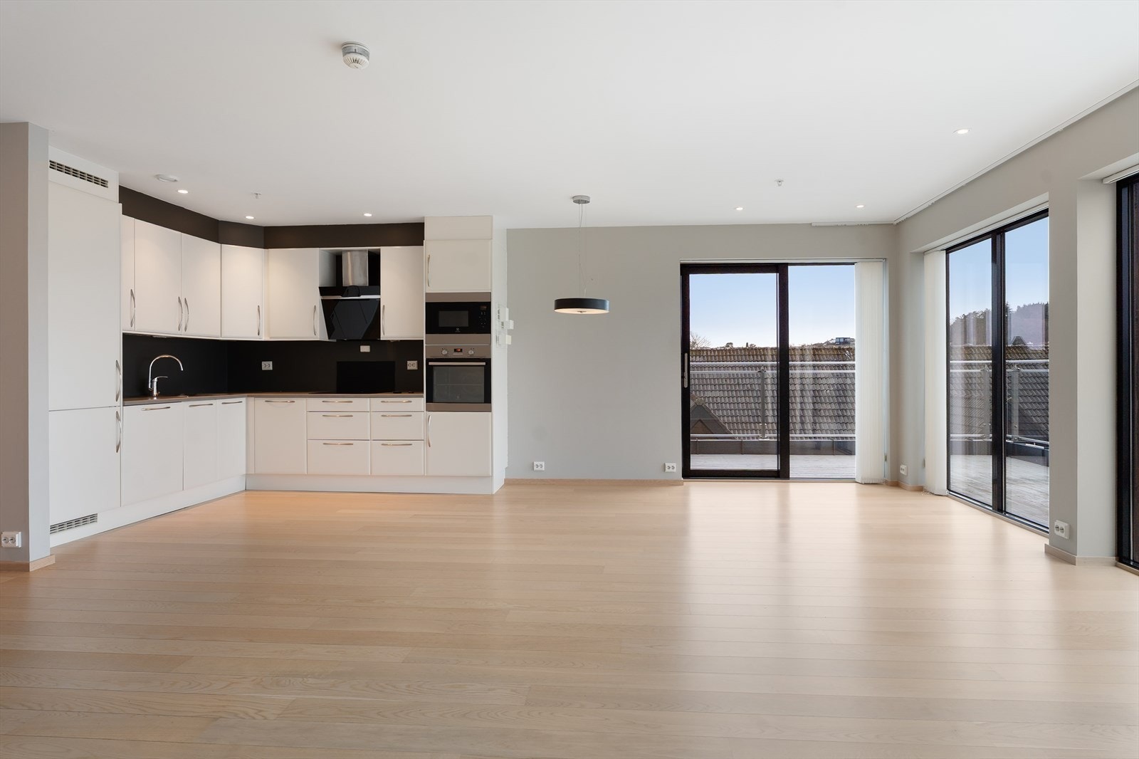 Leiligheten kan by på en lys og romslig stue med åpen kjøkkenløsning Galleribilde