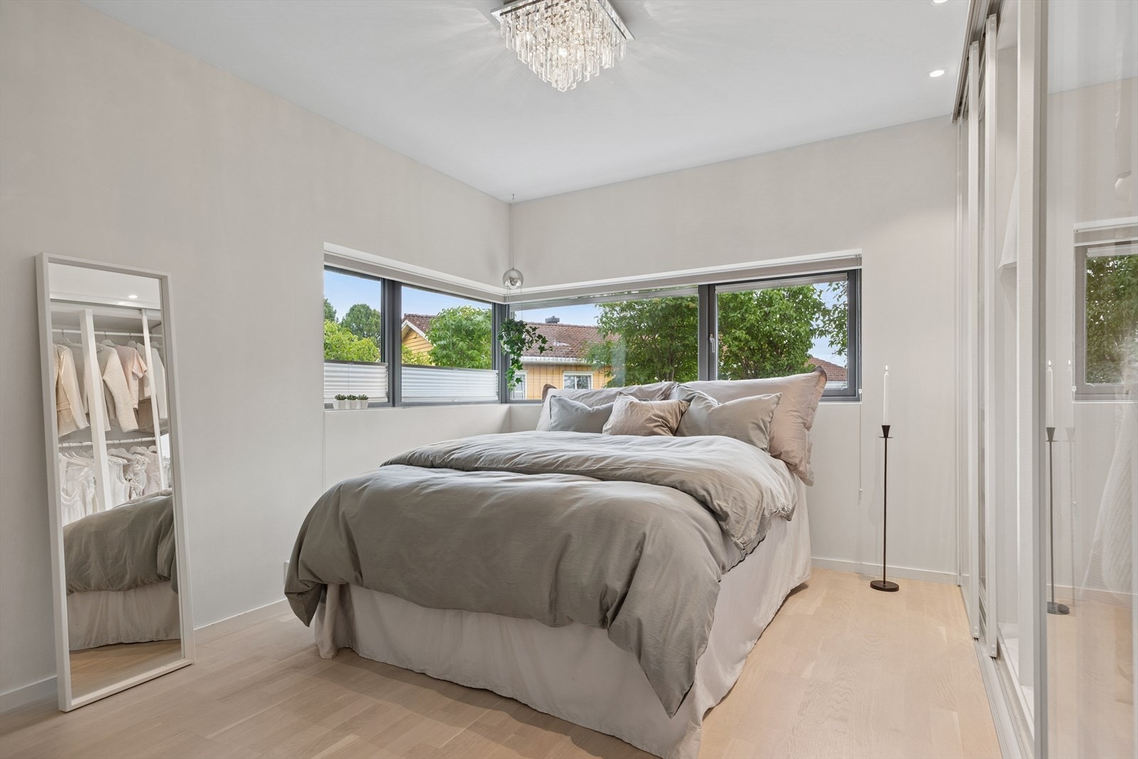 Soverom 3 med stor skyvedørsgardobe i glass ligger ut mot hageområde. Lampe i tak medfølger ikke. Galleribilde