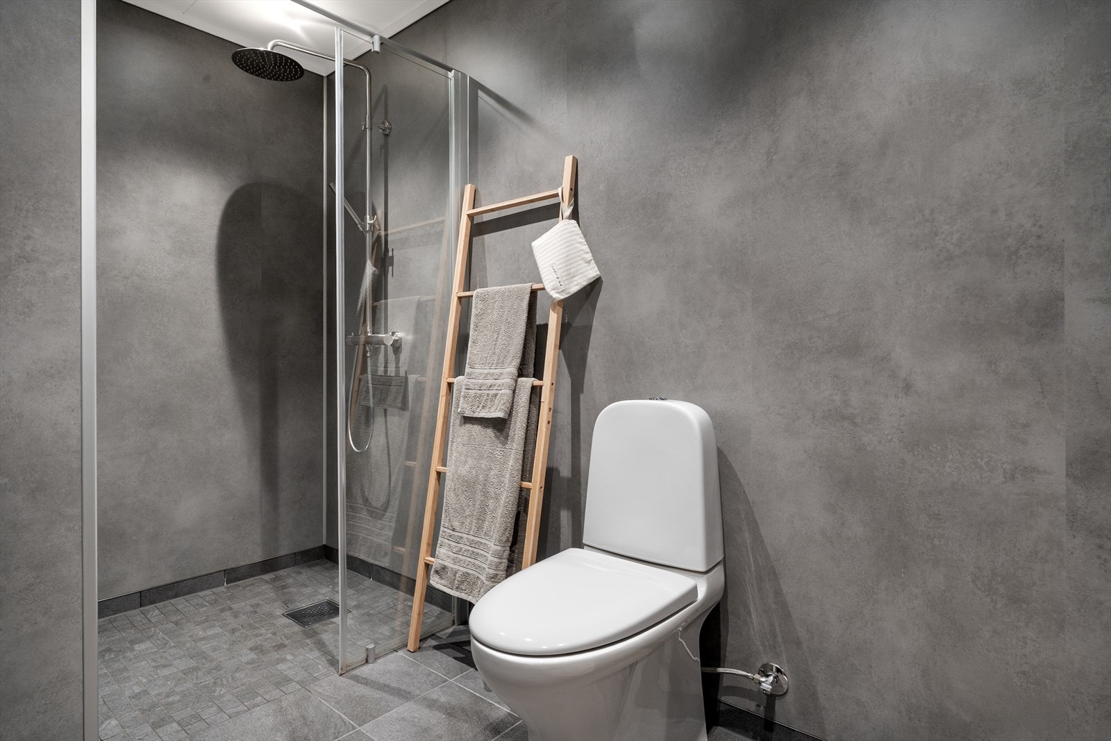 Bad er innredet med toalett, dusjhjørne og innredning med servant. Galleribilde