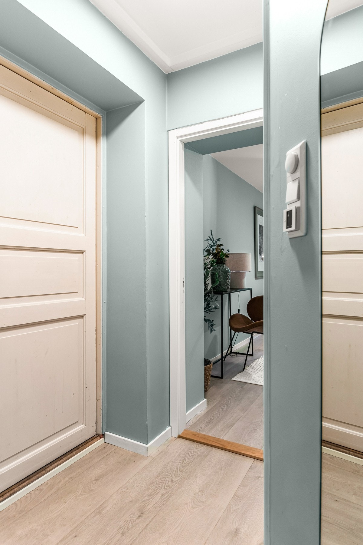 Entreen deler leiligheten i 2, hvor kjøkken og stuedelen er på den ene siden og soverom er på den andre. Midt i mellom har du et flislagt baderom Galleribilde