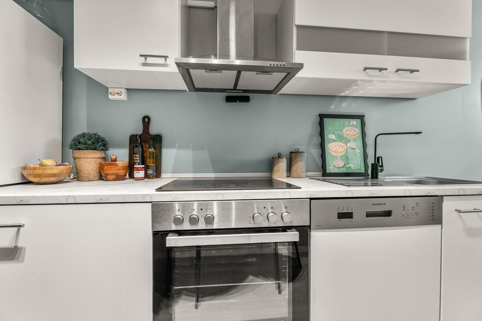 Kjøkkeninnredning med finerte fronter, laminat benkeplate, oppvaskkum, hetteventilator,
vaskemaskin, oppvaskmaskin, kjøleskap m/fryseboks, stekeovn og keramisk platetopp. Komfyrvakt
er montert. Galleribilde