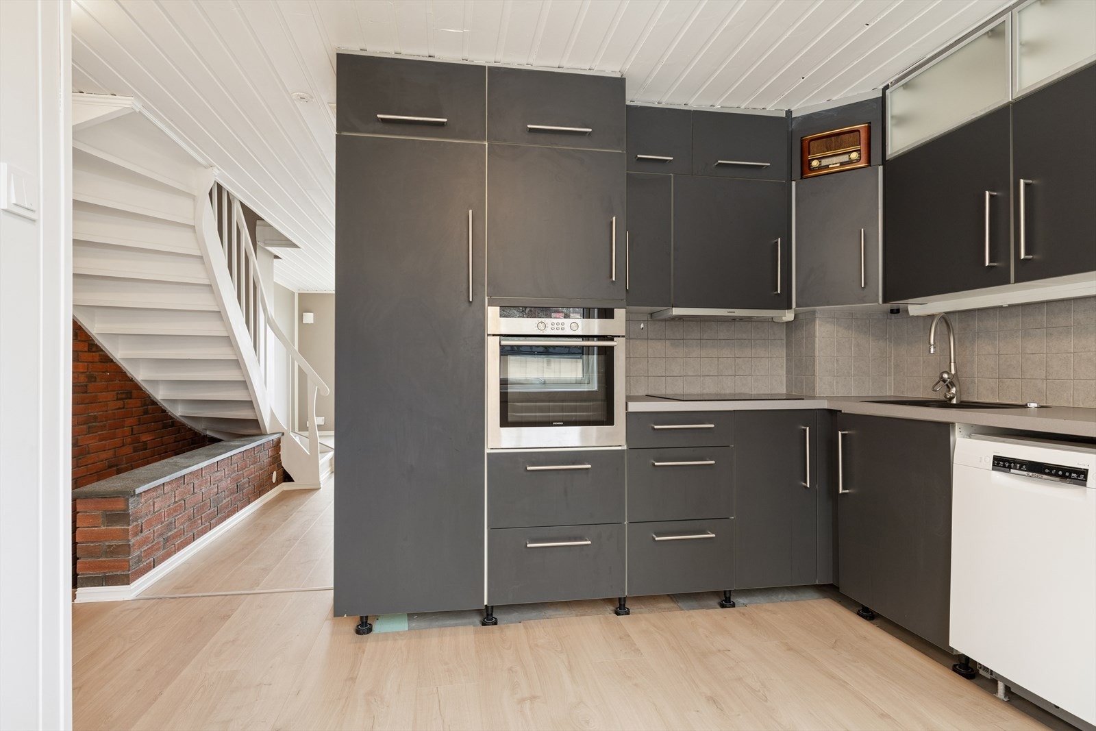 Moderne kjøkkeninnredning med slette fronter og integrert komfyr med platetopp. Galleribilde