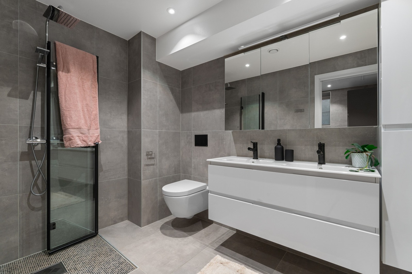 Badet i nederste etasje har også inngang til et innebygd vaskerom, som er adskilt med skyvedør. Galleribilde