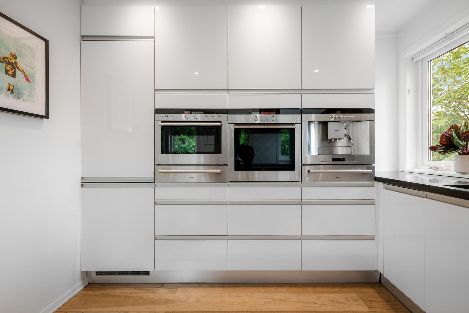 Over benk er det fliser på vegg, og kjøkkenet er utstyrt med integrert kjøl/frys, oppvaskmaskin, stekeovn og mikrobølgeovn med stekefunksjon. Galleribilde