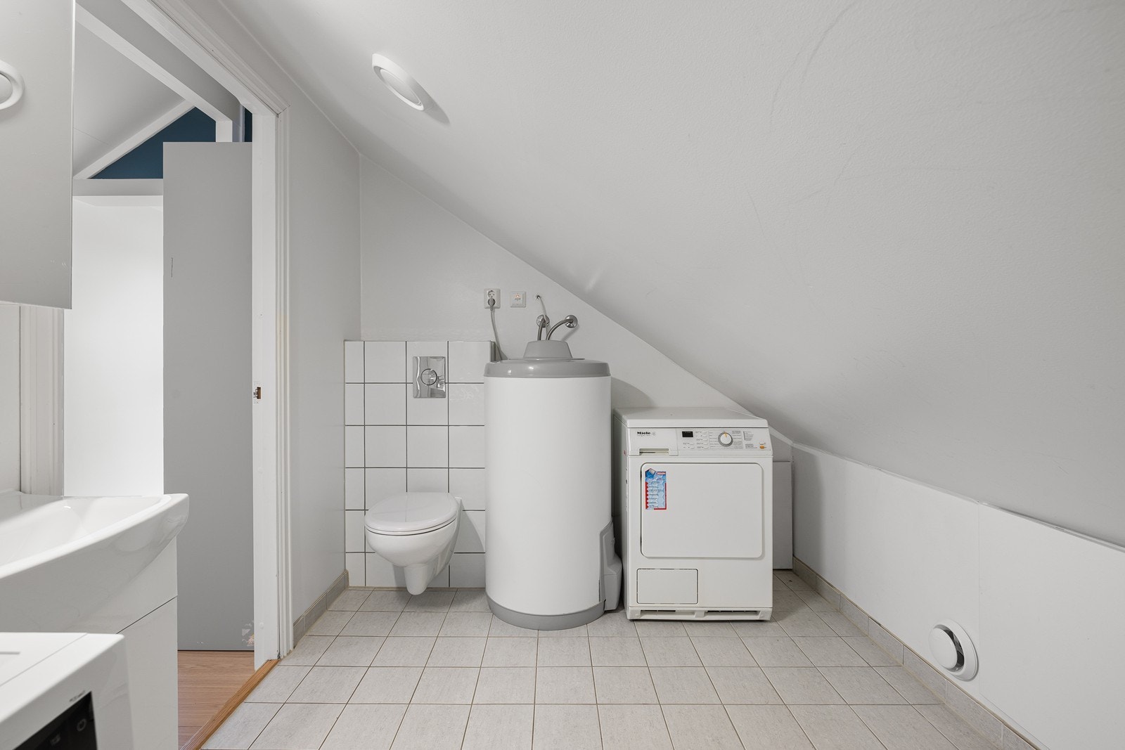 Rommet fungerer i tillegg utmerket som vaskerom, med ferdig opplegg og god plass for både vaskemaskin og tørketrommel, noe som gjør boligen svært praktisk for barnefamilier. Galleribilde