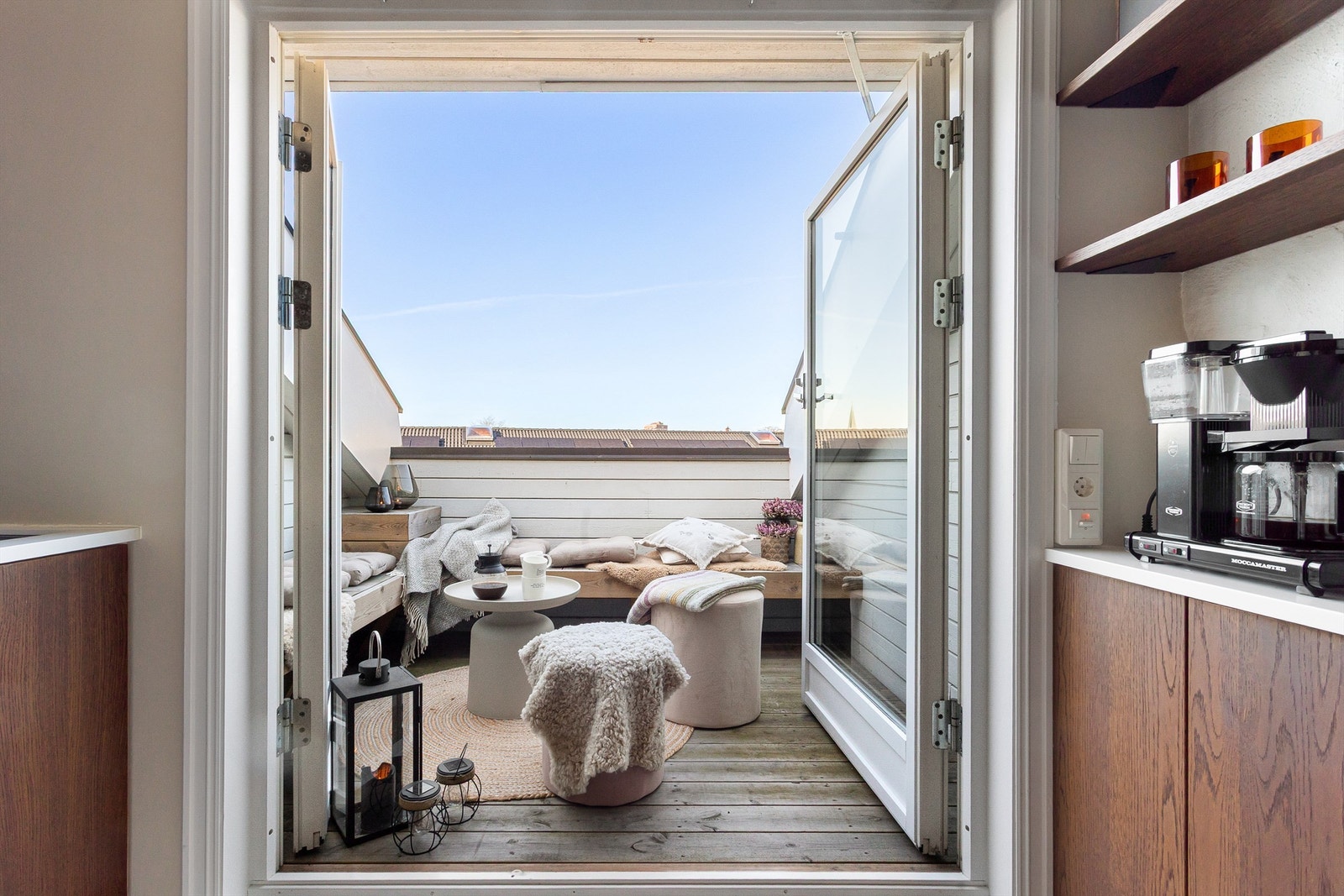 Fra kjøkkenet åpner dørene seg ut til en solrik takterrasse, et lite fristed over byens tak Galleribilde