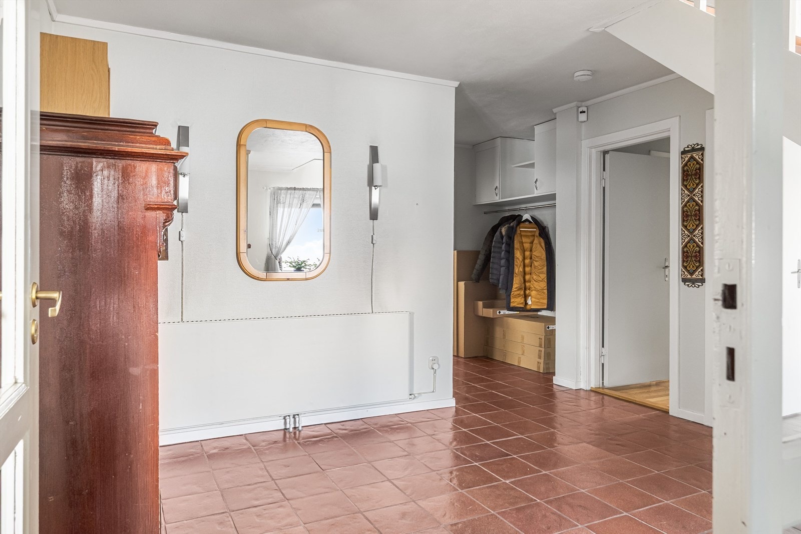 Videre kommer du inn i romslig gang/trapperom. Praktisk med flislagt gulv og oppvarming med stor radiator. Galleribilde
