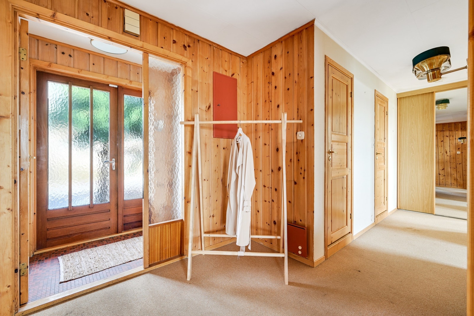 Inngangspartiet er romslig med vindfang og entre til husets 2 soverom, wc og bad, samt stue og kjøkken. Galleribilde