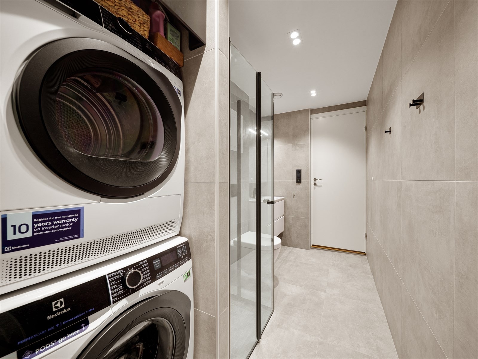 Badet har en nedsenket dusjsone med innfellbare dusjdører i glass, som gir et stilrent uttrykk og effektiv utnyttelse av plassen. Galleribilde