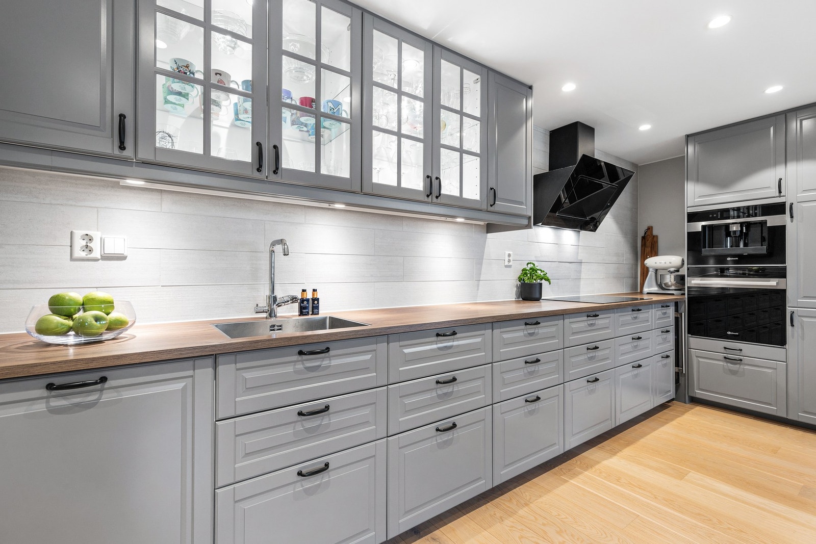 Kjøkkenet har to vitrineskap med integrert belysning og byr på rikelig med både skap- og benkeplass Galleribilde