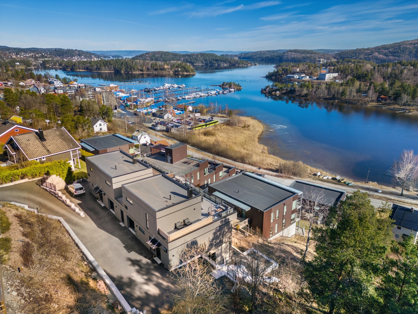 Dronefoto av huset med Sætre sentrum i bakgrunn. Galleribilde