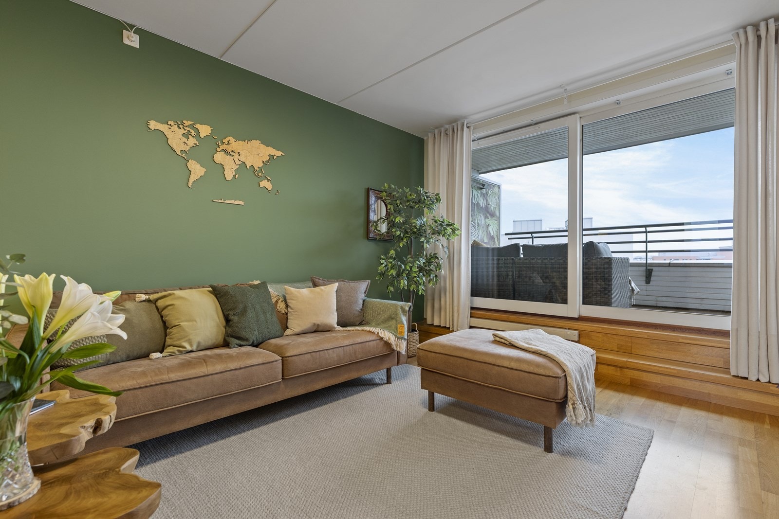 Når den store glassskyvedøren åpnes mot terrassen, oppleves uteplassen som en naturlig forlengelse av stuen. Galleribilde