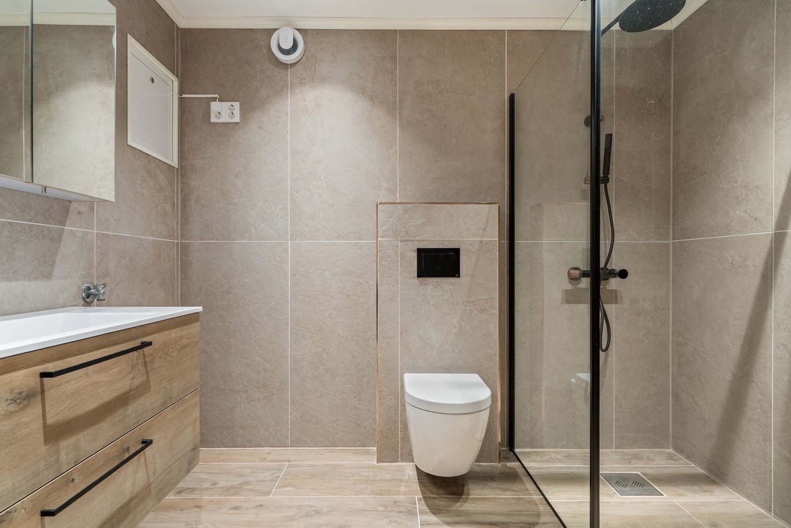 Badet er helt nytt i 2026 og fremstår delikat, med store fliser, vegghengt toalett, moderne innredning og eksklusiv dusjsoneløsning med sorte detaljer. Et rom designet for å gi både spa-følelse og funksjonalitet i hverdagen. Galleribilde