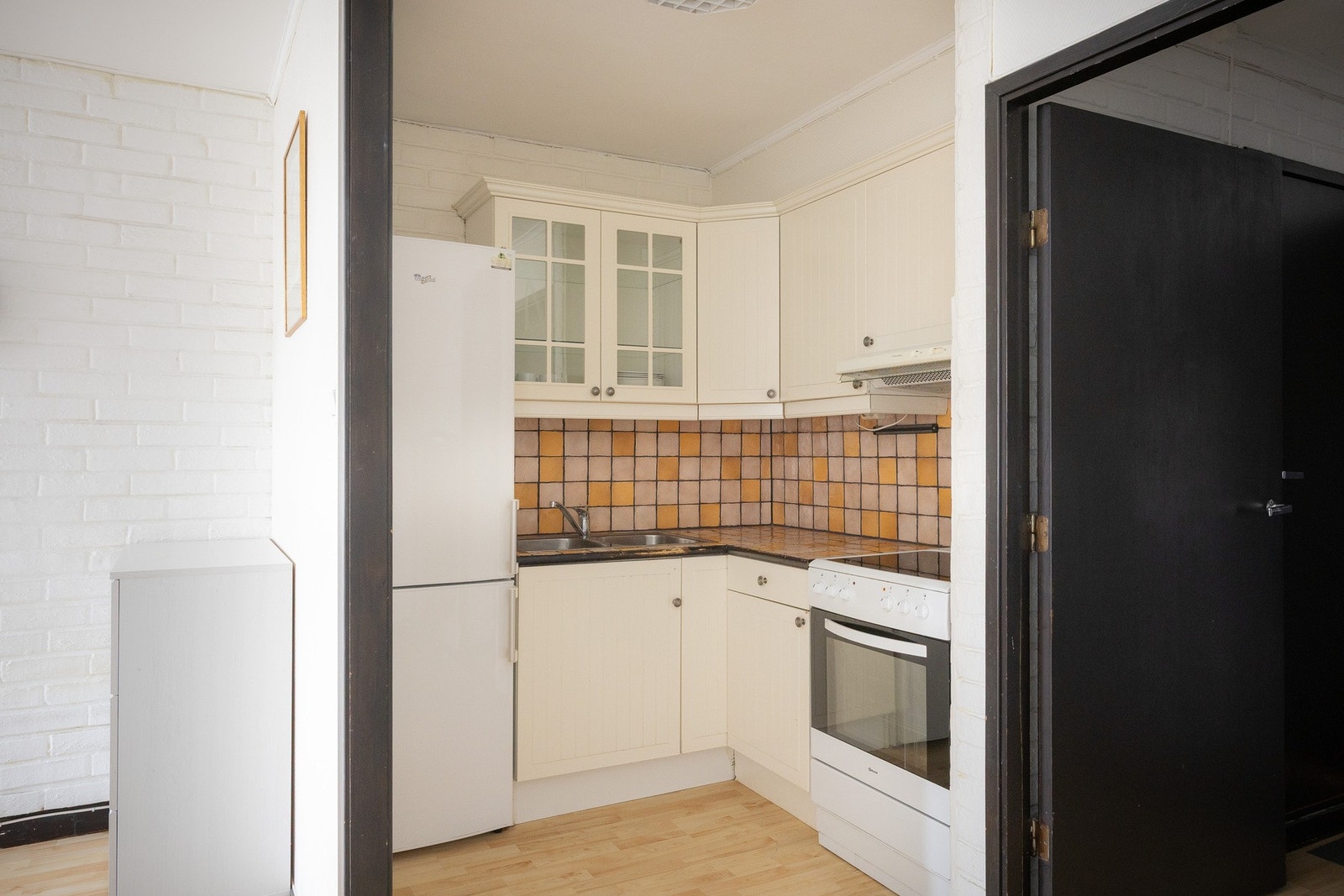 Kjøkkenet har innredning med profilerte fronter og flislagt benkeplate med oppvaskkum samt ettgreps svingbart blandebatteri. Galleribilde