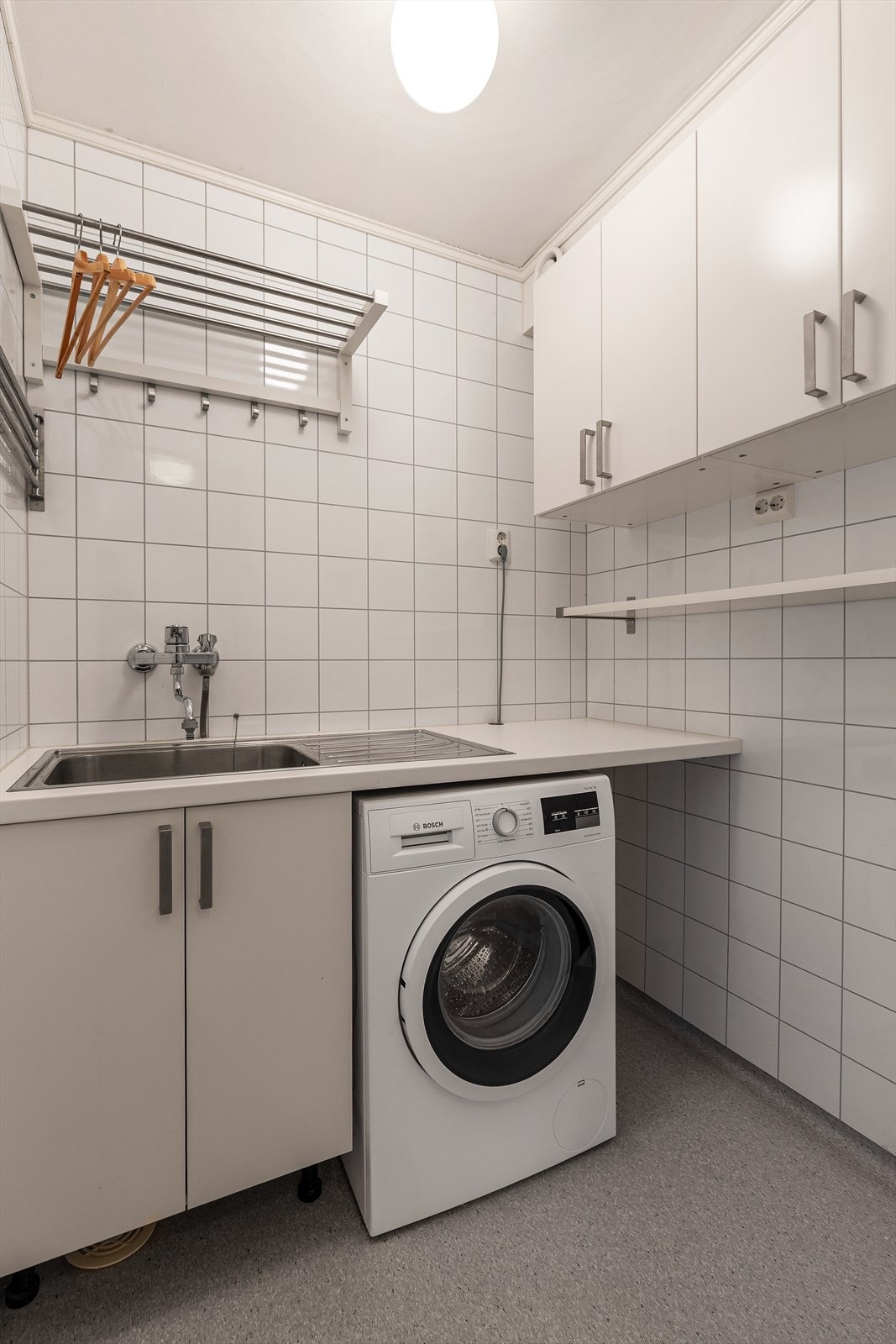 Praktisk vaskerom med benke- og skapplass. Opplegg for vaskemaskin. Galleribilde