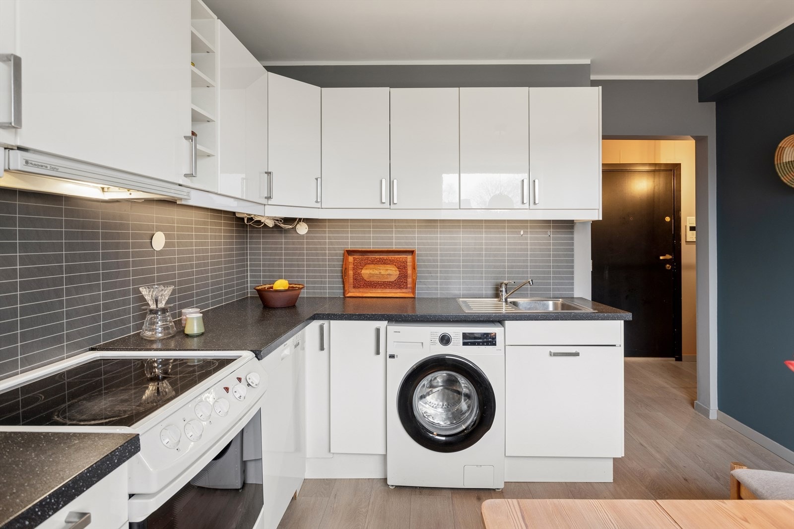 Kjøkkenet er innredet med kjøkkeninnredning med glatte fronter og laminat benkeplate. Galleribilde