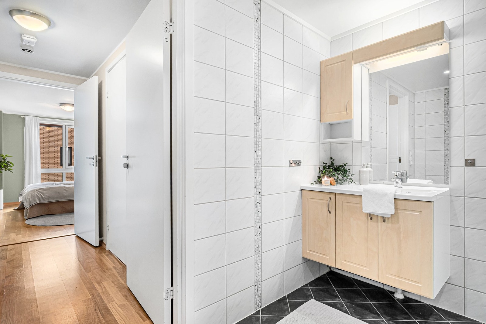 Badet er tidløst med fliser på gulv og vegger med varmekabler i gulvet Galleribilde