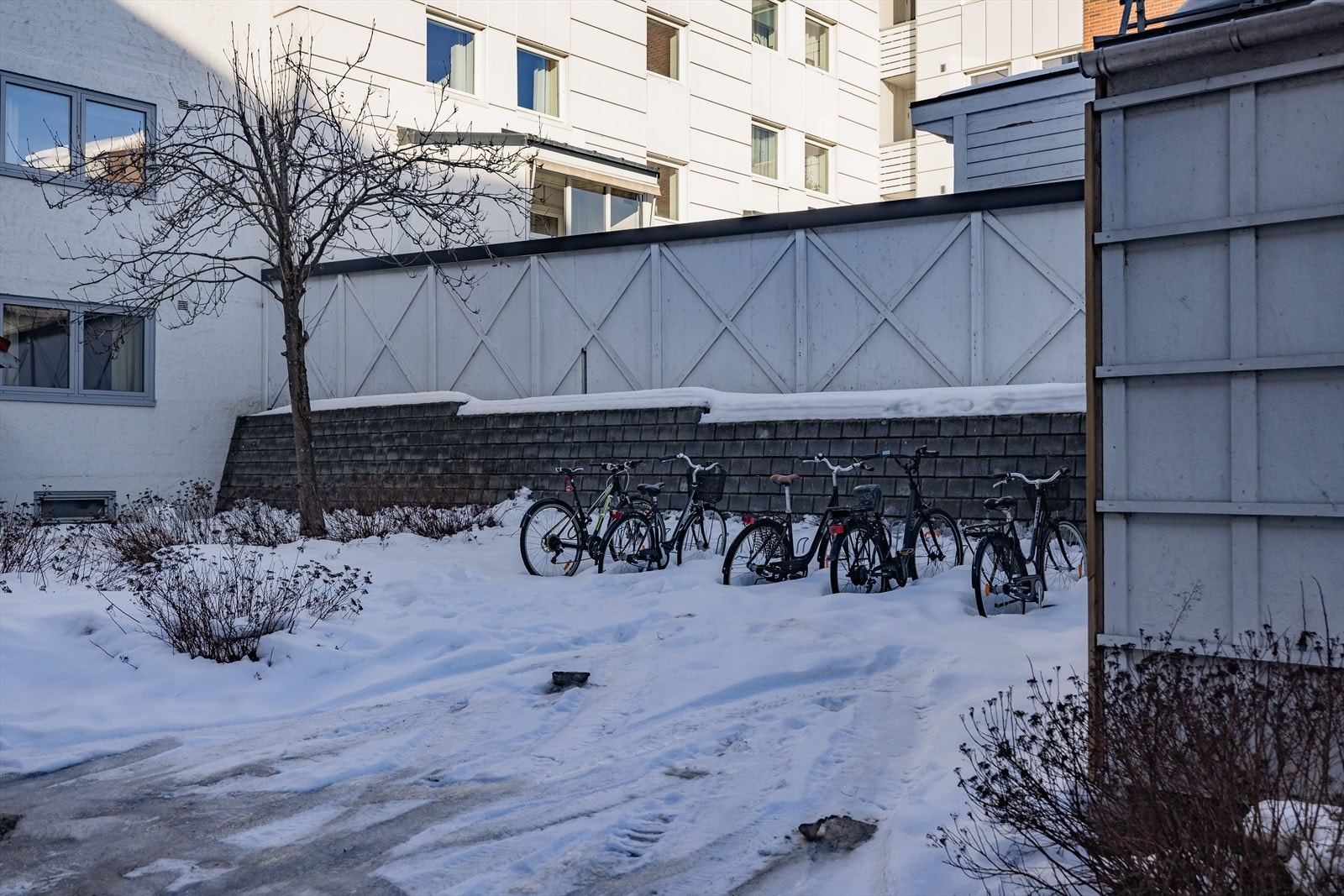 Tomten består av en asfaltert bakgård med som er pent opparbeidet med diverse beplantning, utebelysning og sykkelparkering. Galleribilde
