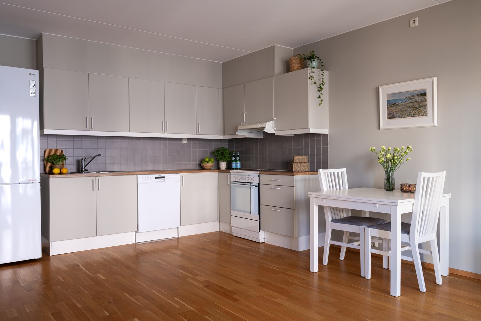 Lyst Sigdal-kjøkken med glatte fronter, laminat benkeplate og nedfelt oppvaskkum. Galleribilde