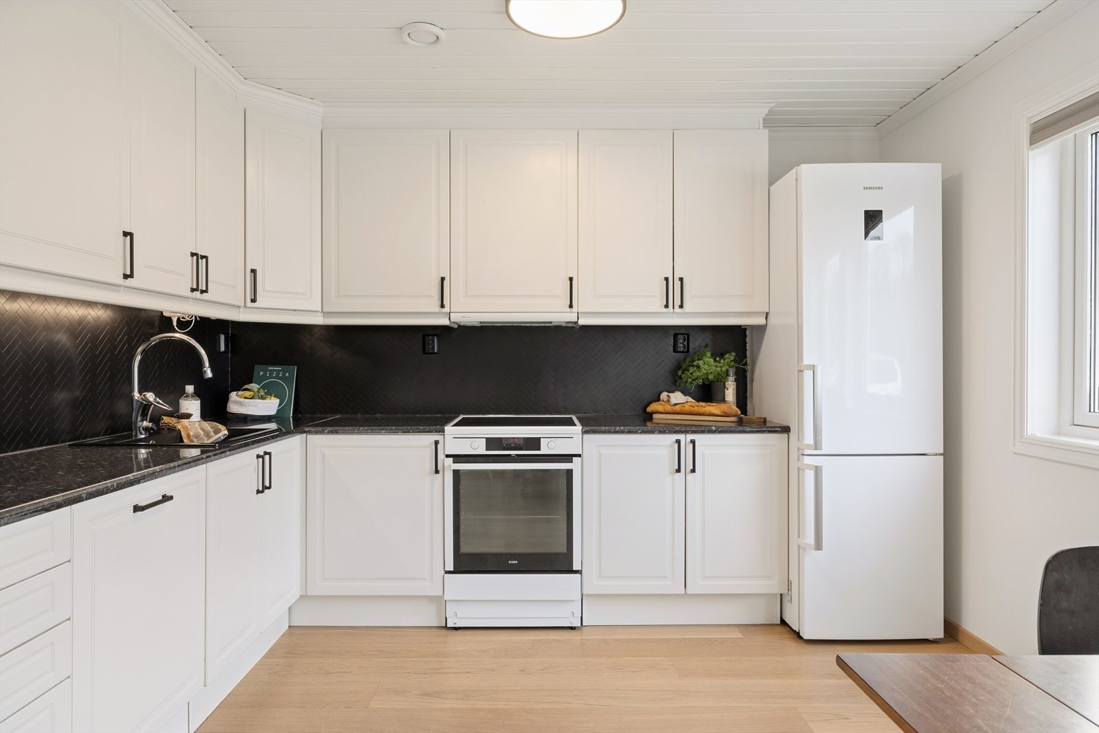 Kjøkkenet er innredet i en praktisk form, og har godt med både skap- og benkeplass. Galleribilde