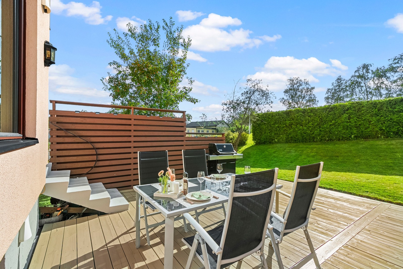 På terrassen er det dekke i tre, og på husveggen er det montert utebelysning. Galleribilde