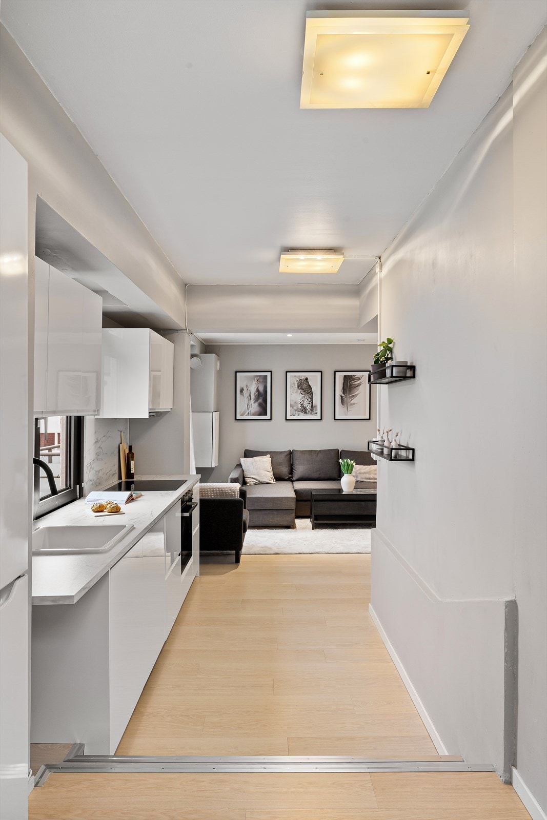 Den åpne kjøkkenløsningen mot stuen gjør dette til et sosialt rom som egner seg perfekt for hverdagsmatlaging og gjester. Galleribilde