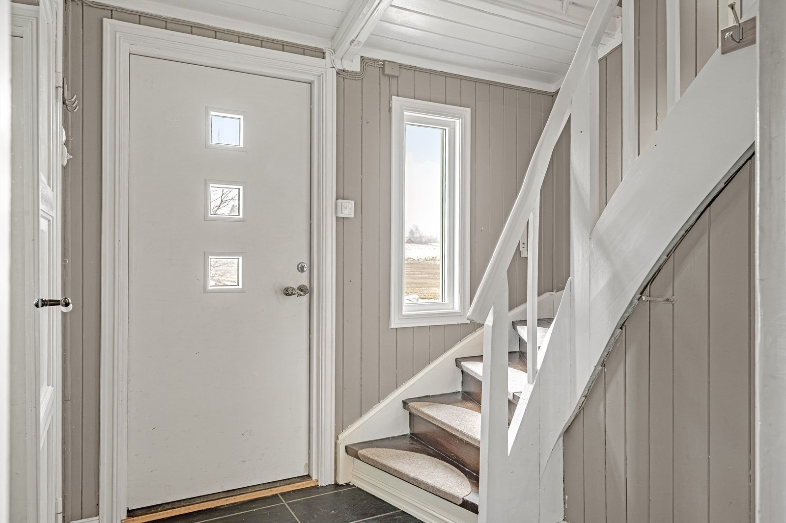 Entré med inngangsdør fra 2016 og med praktisk og flislagt gulv som har varmekabler. Her finner du også trappen opp til 2. etasje. Galleribilde