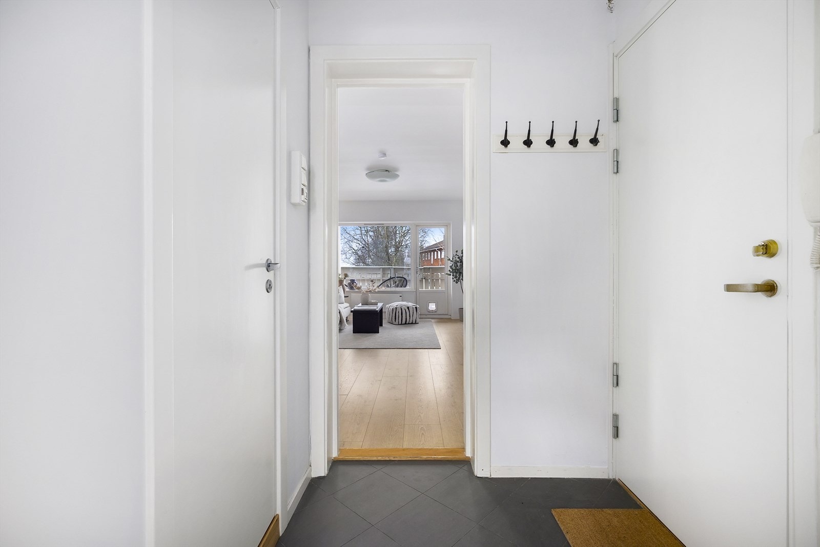 Velkommen inn i en lys entré med flislagt gulv. Her er det plass til både skoskap og knaggrekke. Galleribilde