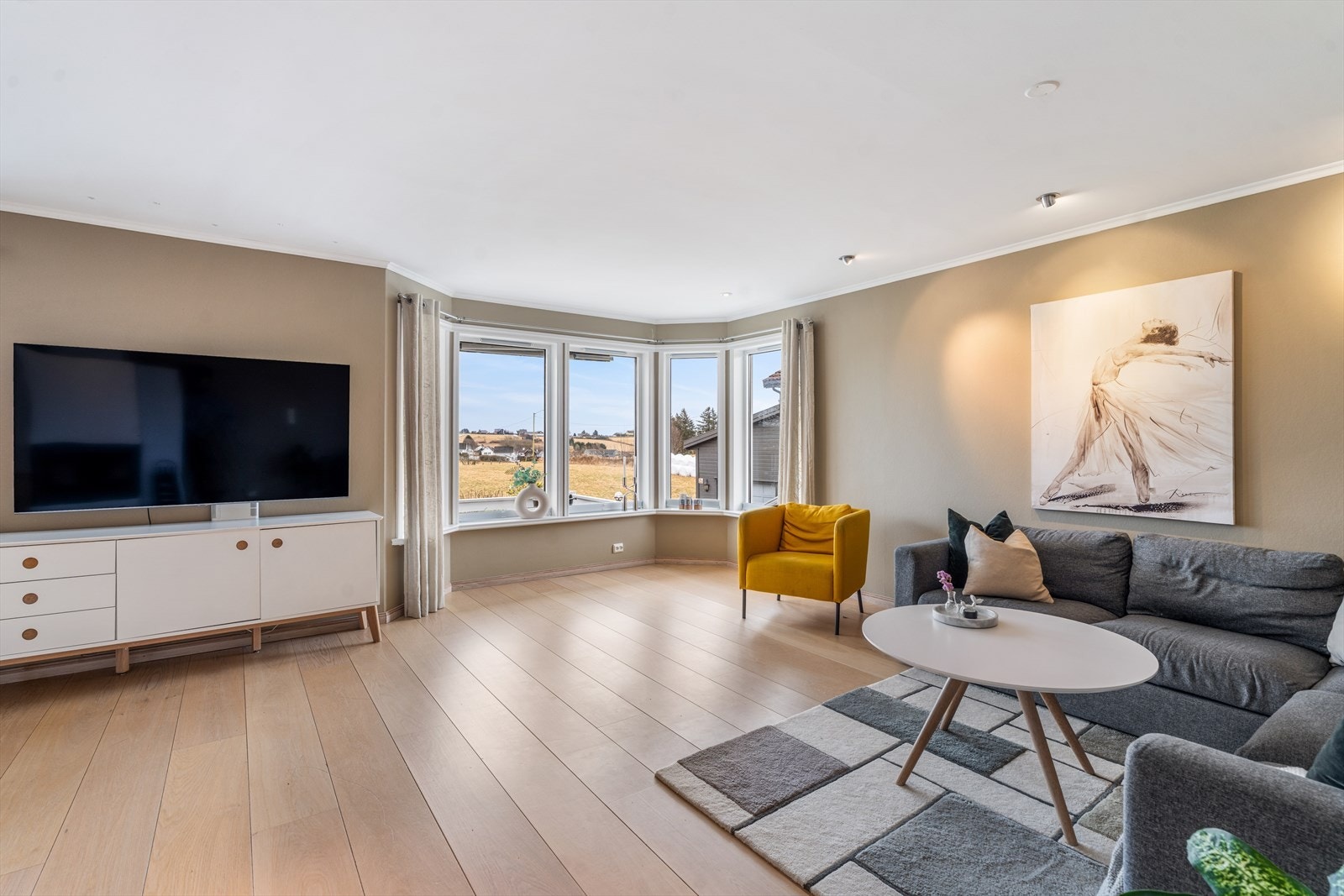 Stuen er lys og luftig med store vindusflater som gir utsikt mot landskapet. Galleribilde