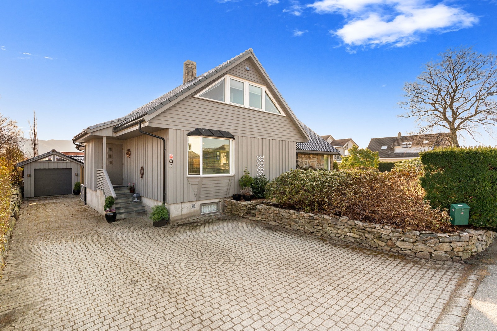 Belegginstein i gårdsrom - bakerst ser man husets garasje Galleribilde