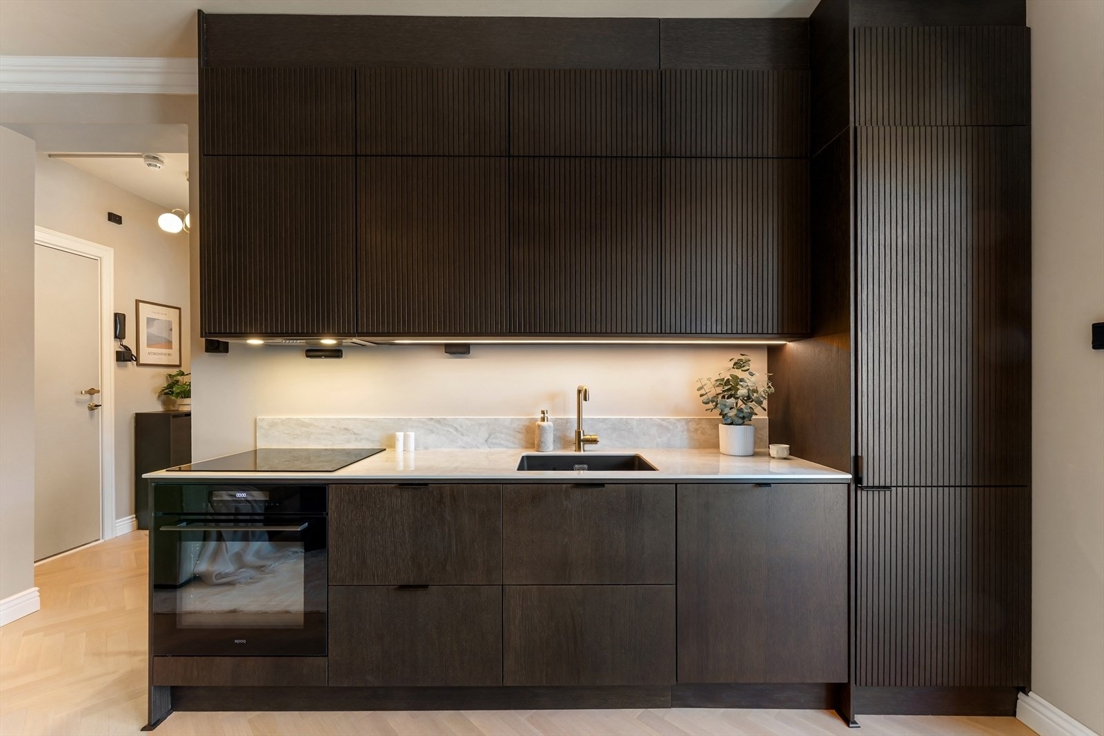 Kjøkkenet er stilrent utført med innredning fra Epoq (2025) og mørke eikefronter som tilfører varme og karakter. Galleribilde