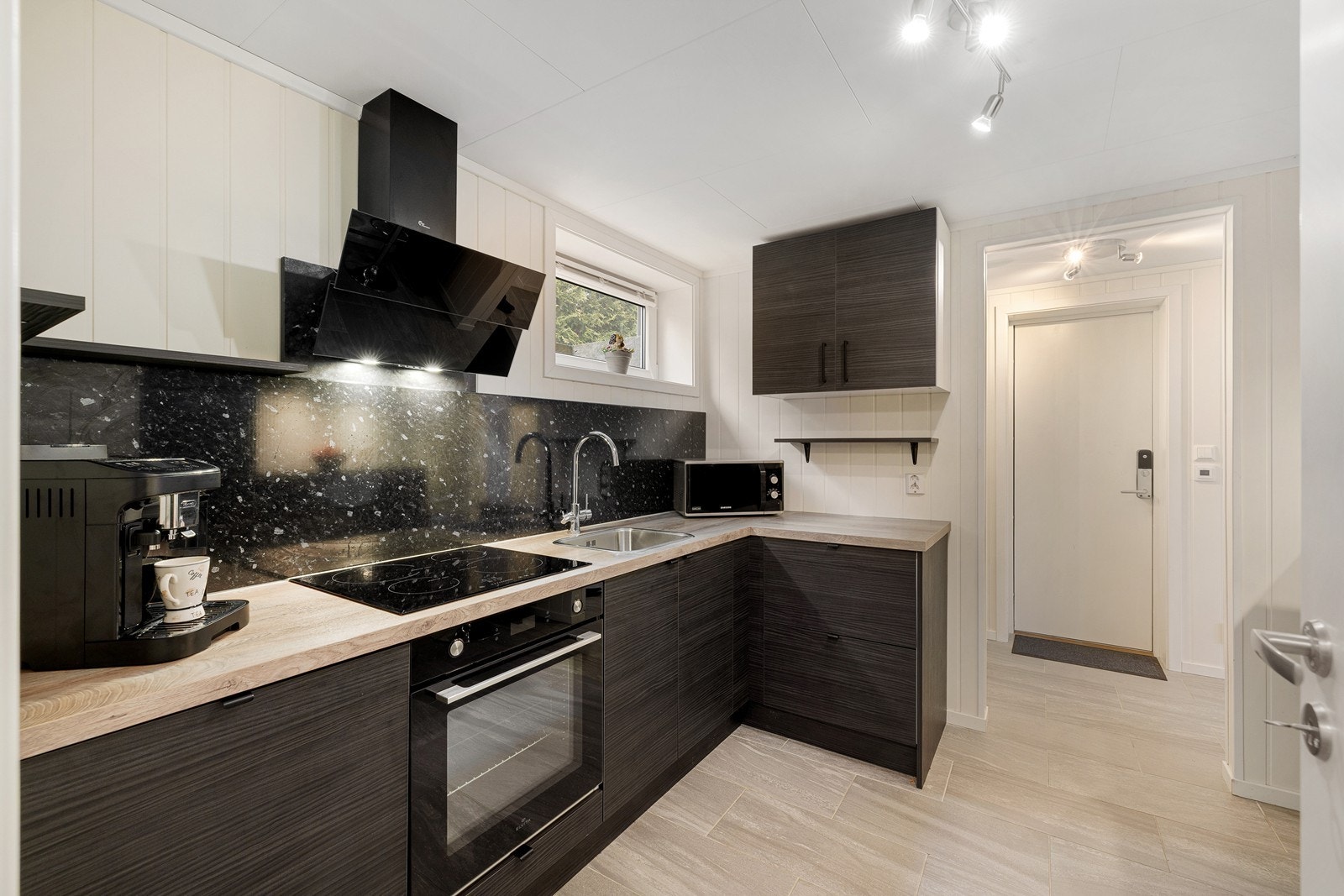 Kjøkkeninnredningen har laminert benkeplate med nedfelt oppvaskkum og 1-greps blandebatteri. Galleribilde