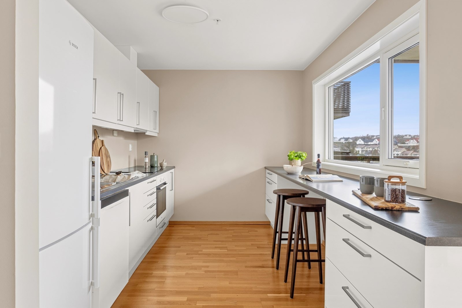 Kjøkkeninnredning fra Sigdal, med slette fronter, laminat benkeplate og kjøkkenvask i rustfritt stål Galleribilde