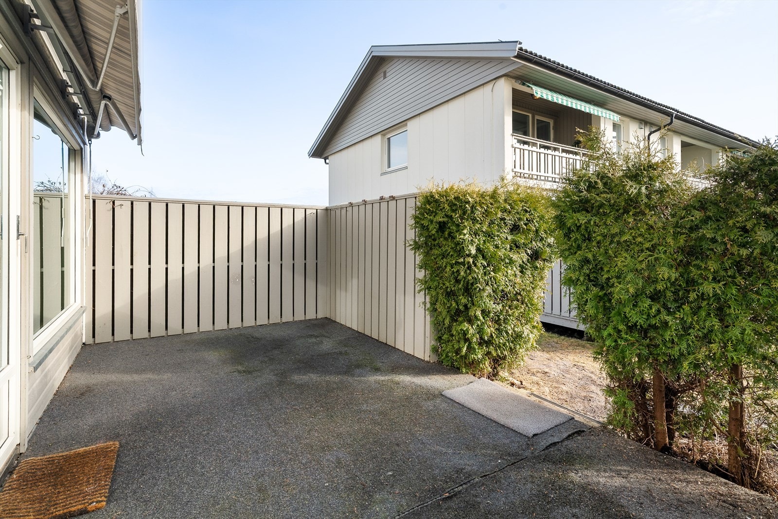 Terrassen er innrammet med levegger og hekk som gir en lun og skjermet uteplass. Galleribilde