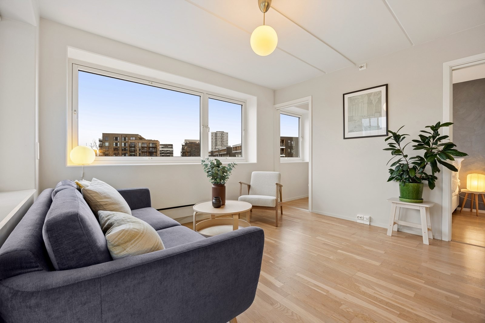 Lys og romslig stue med store vindusflater og god plass til sittegruppe Galleribilde