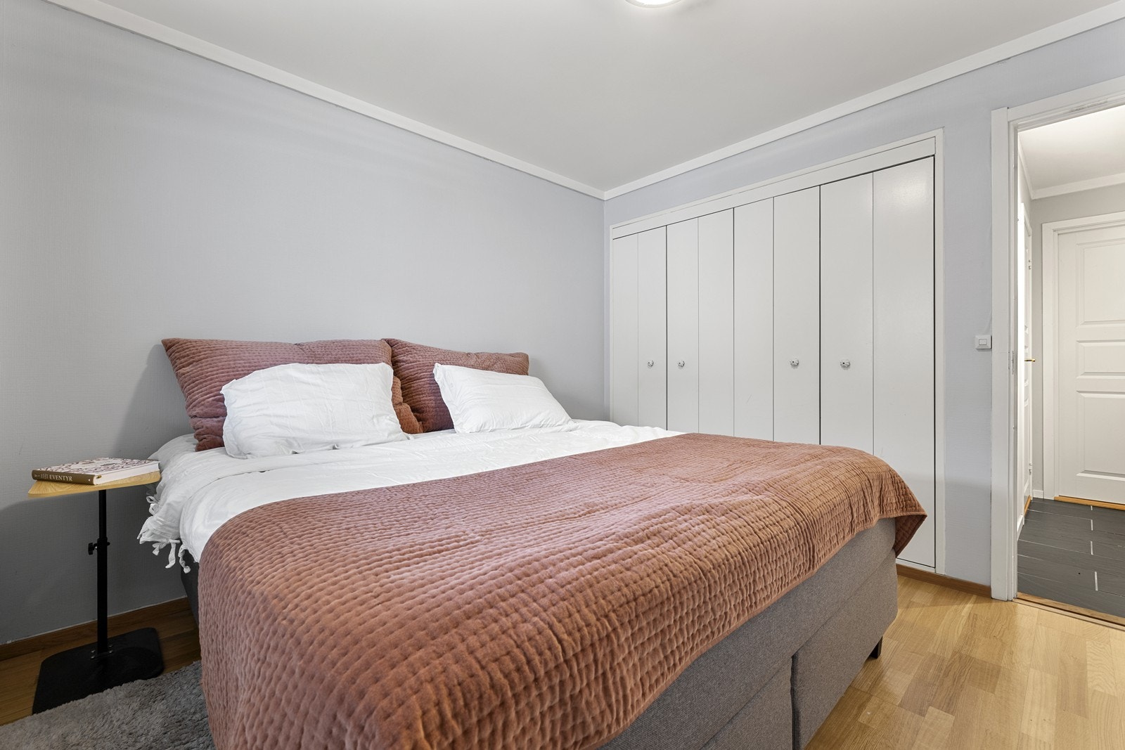 Rommet er stort med plass til dobbeltseng og tilhørende nattbord og plassbygget garderobe. Galleribilde