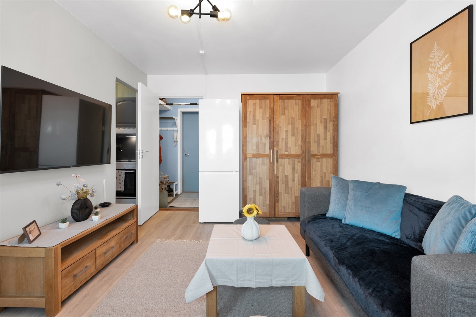 Leiligheten har moderne, lyse overflater med parkett på gulv i stuen. Galleribilde