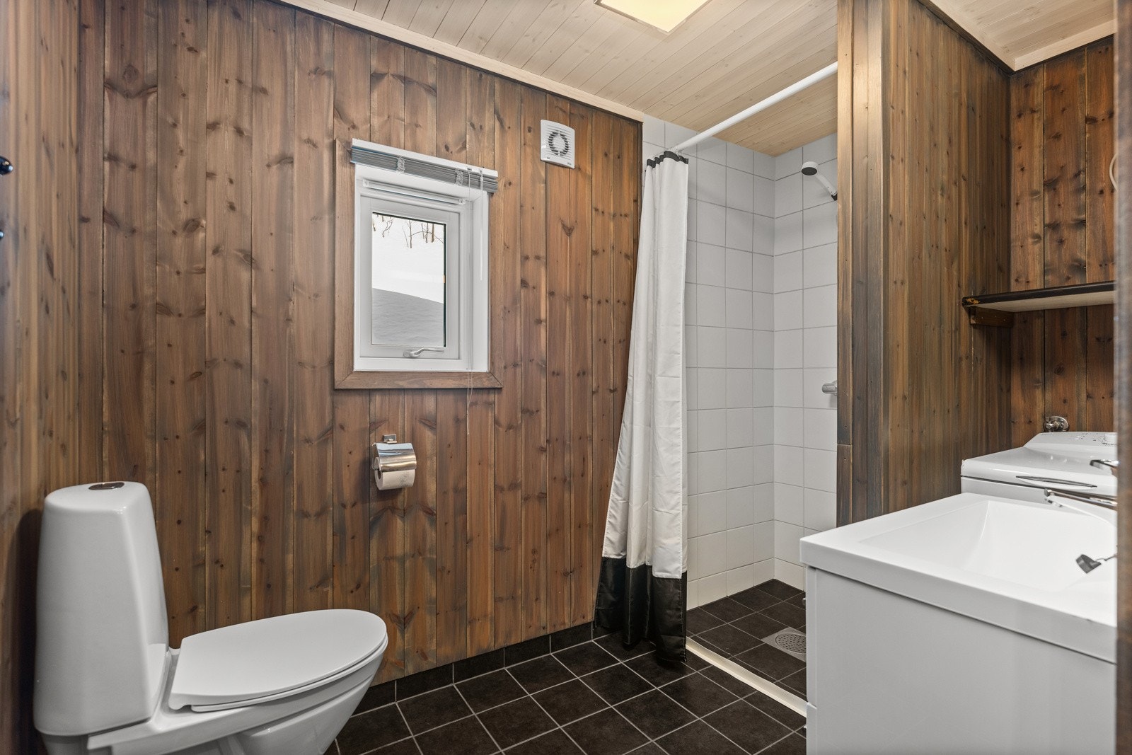 Bad I har også dusjnisje med fliser og opplegg til vaskemaskin. Galleribilde