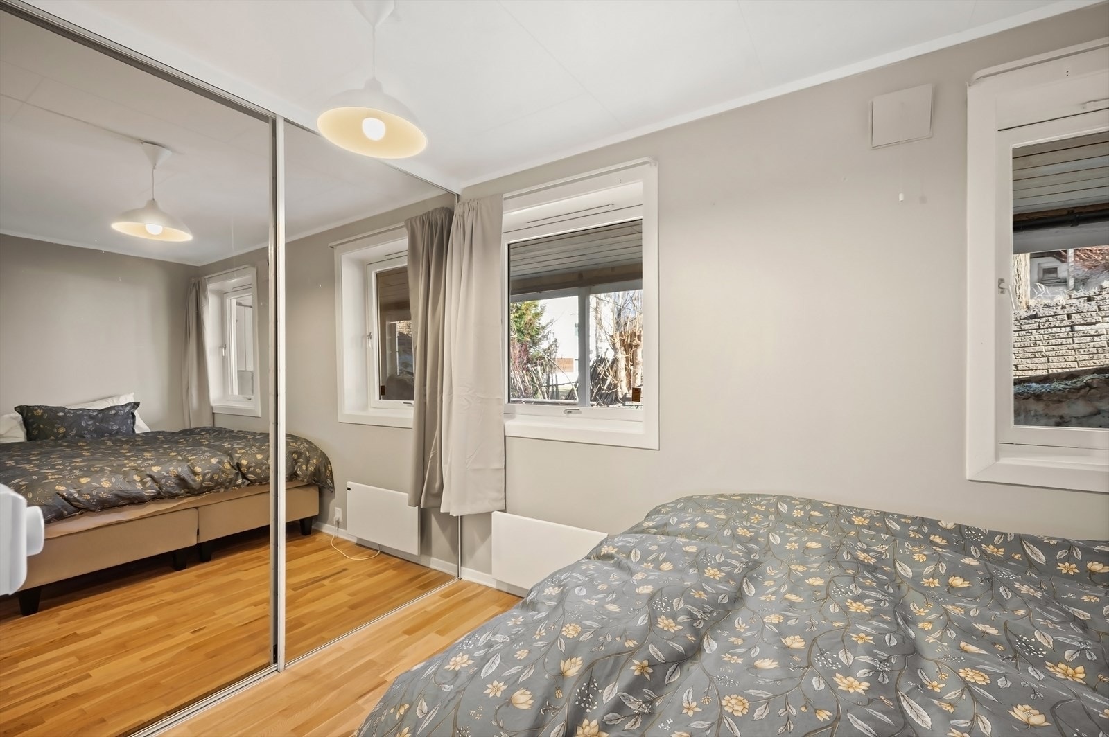 Romslig soverom med stor skyvedørsgarderobe langs hele den ene siden av soverommet. Galleribilde