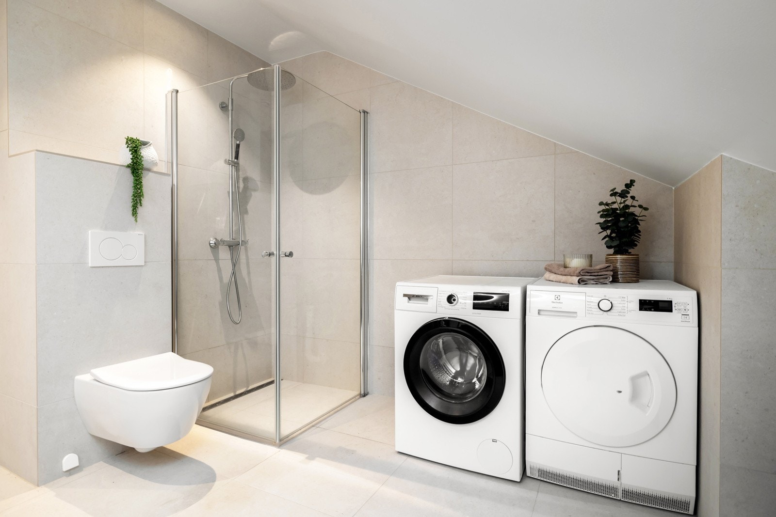 Bad nummer én har fliser på gulv og vegger i format 59 x 59 cm, malt overflate og downlights i himling. Det er elektrisk gulvvarme og mekanisk avtrekk Galleribilde