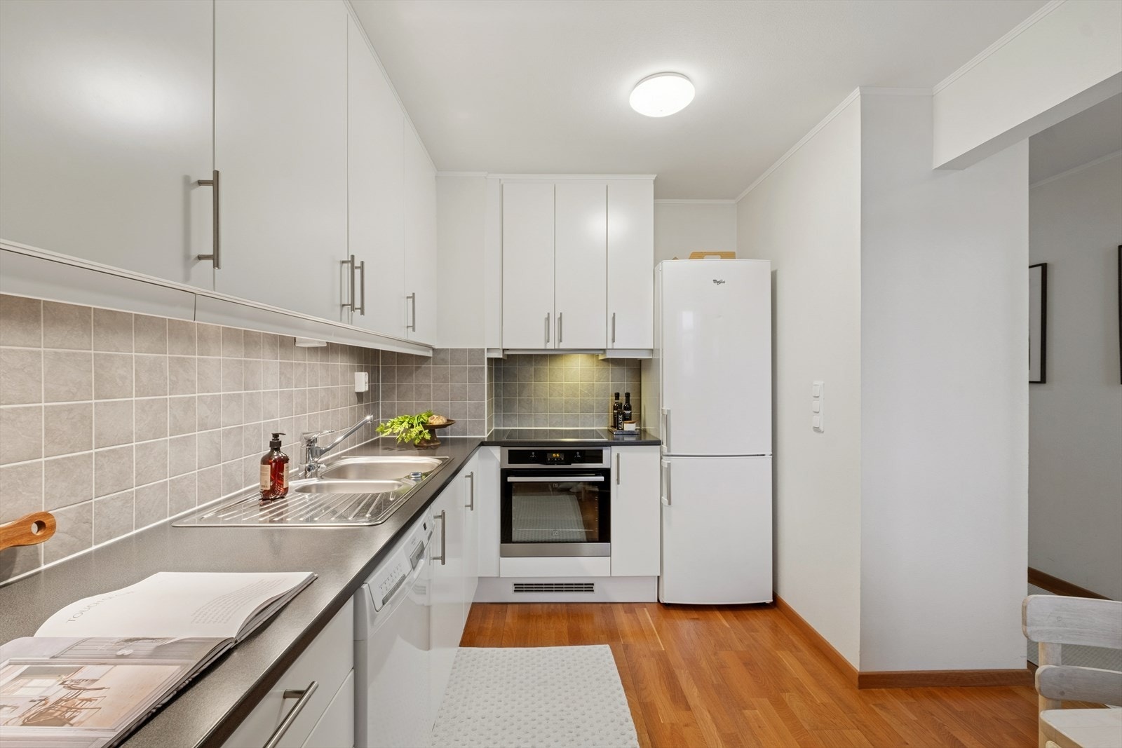 Kjøkkenet er arealeffektivt. Det er integrert platetopp og stekeovn, samt frittstående oppvaskmaskin og kjøle-/fryseskap, som alle medfølger. Galleribilde