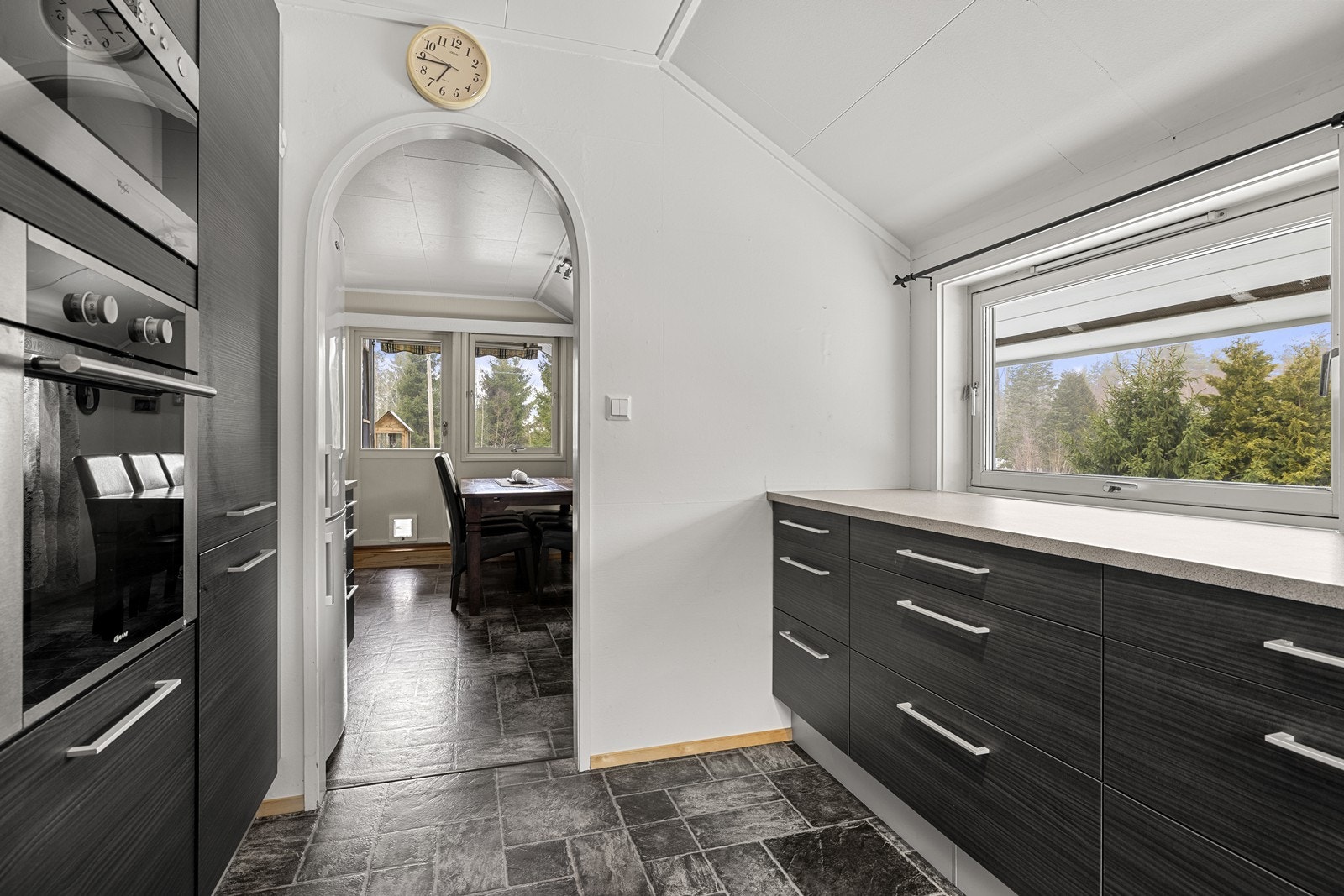 En praktisk bueåpning leder fra kjøkkenet og videre til spisekroken. Galleribilde