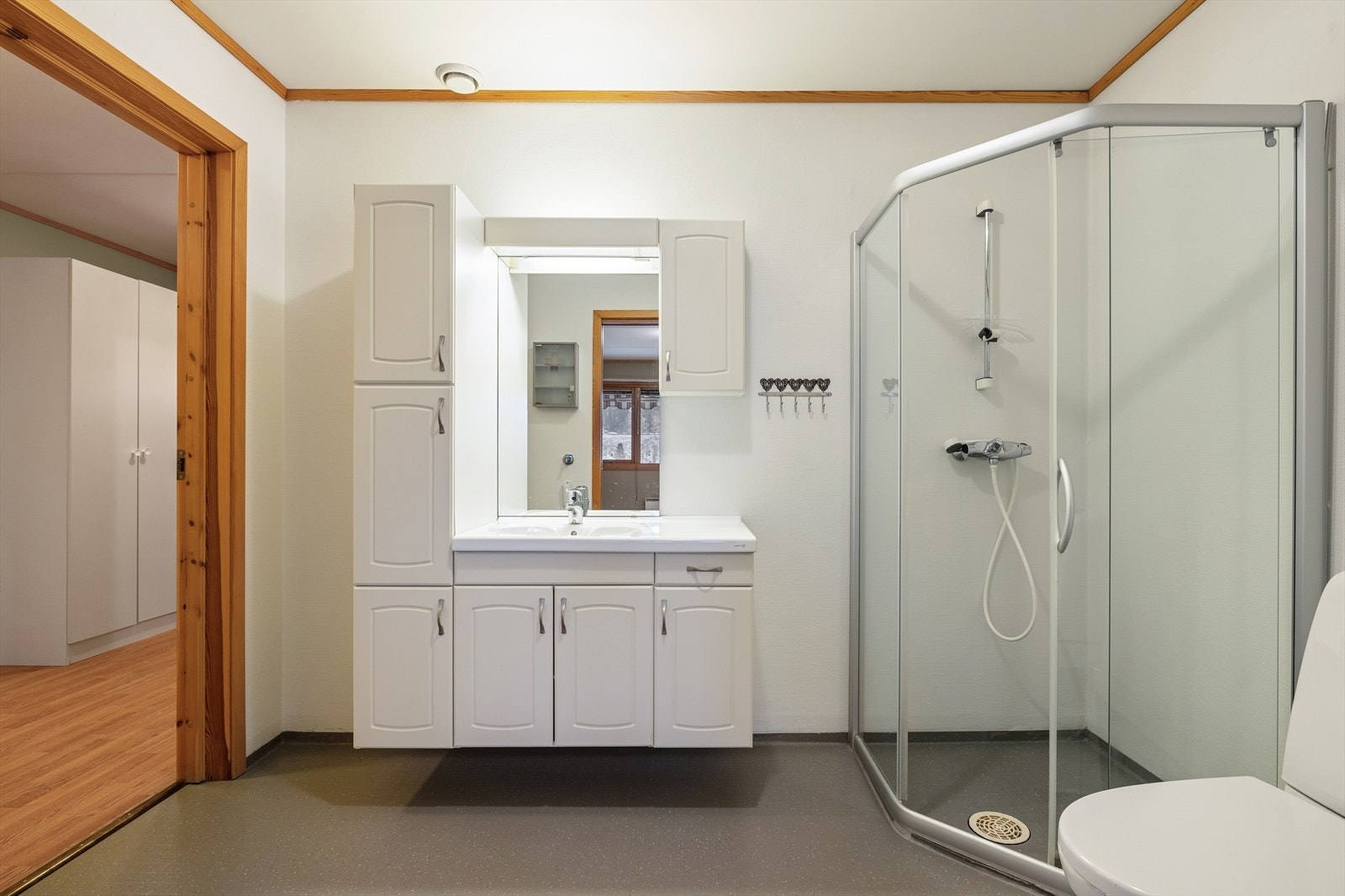 Badet er utstyrt med en lys og romslig baderomsinnredning. Her er det rikelig med oppbevaringsplass for baderomsartikler. Galleribilde