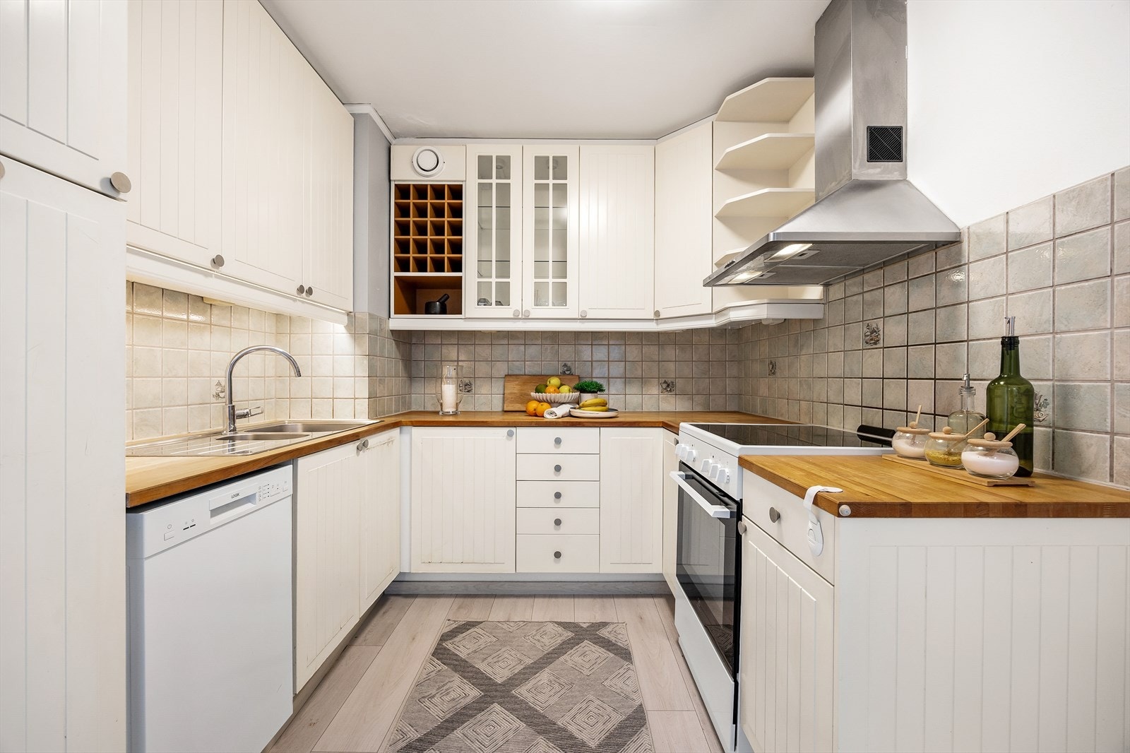 Praktisk og velutnyttet kjøkken med profilerte fronter og benkeplate i tre. Galleribilde