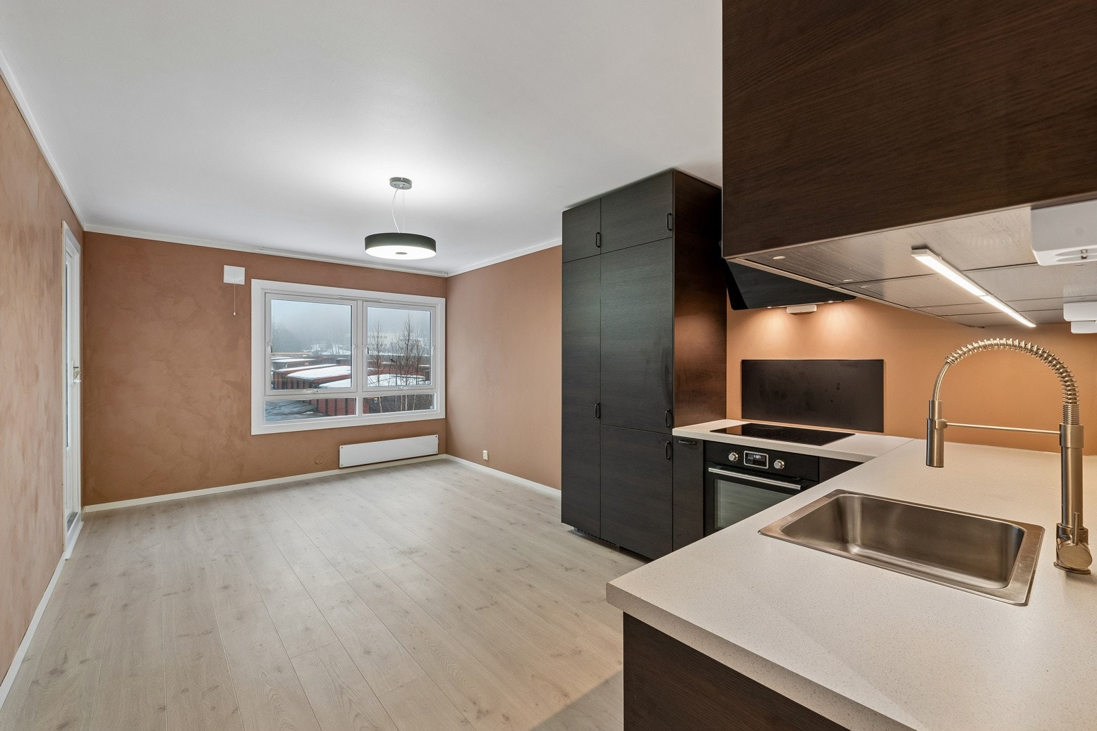 Det er en sosial og fin løsning på kjøkken/stue med stor vindusflate og godt med lys. Galleribilde