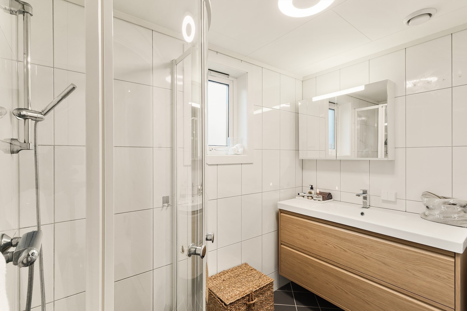 Flislagte vegger og gulv med varmekabler gir badet et funksjonelt og stilrent uttrykk. Galleribilde