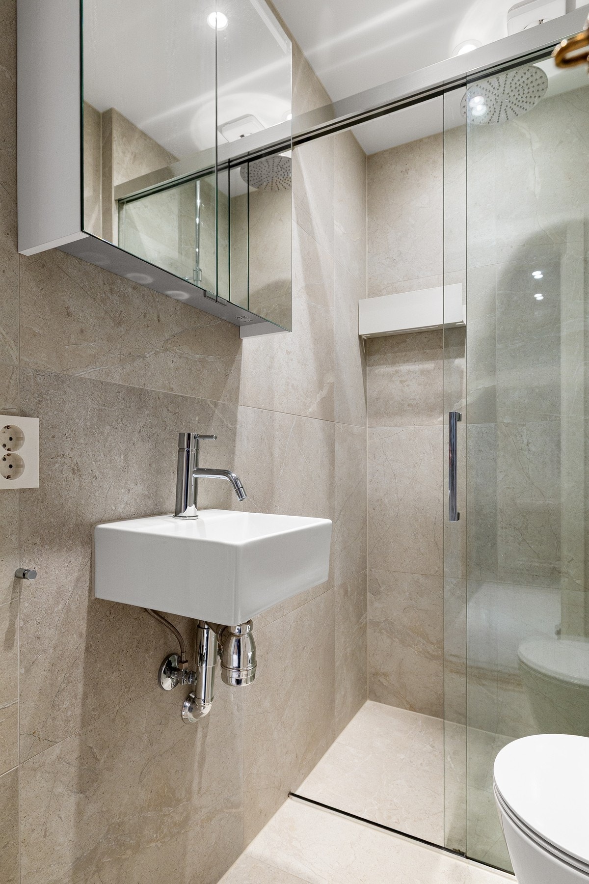 Tile insert sluk i samme flis som gulvet. Meget romslig dusj med både waterfall- og hånddusj. Galleribilde